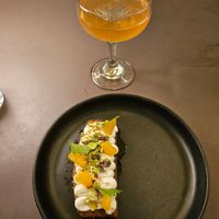 Orange cake slice topped with the creme fraiche, orange, and pistachios at Beyla in Copenhagen