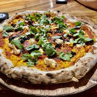 Small vegan pizza with arugula, spinach, wild mushrooms, and free basil and chili oil and vegan parmesan.  at Gorgonzola Pizza & Pasta - El Nido in El Nido