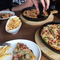 Top Pizza - Vegan meatfeast medium pizza (vegetarian option meat swapped out for sweetcorn). 
Bottom Pizza - Vegan veggie sausage medium pizza.
Both with vegan cheese and ordered with small portion of fries. at Mr Singh's in Birmingham