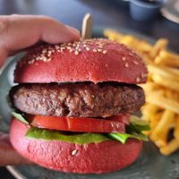 Vegan burger in hand at Kaliva On The Beach in Ayia Napa
