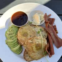 Vegan fried eggs with avocado and vegan bacon.   at Harrow and Harvest Cafe in Lilydale