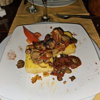 Grilled polenta with mushrooms and dried tomatoes. at Farolim in Santa Maria