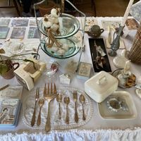 Table with vintage decorations and some artists' work at Ksana 크샤나 in Busan