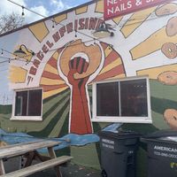 Mural by outdoor seating at Bagel Uprising in Alexandria