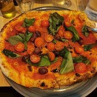 Pizza Sicilienne with olive at Café Victoria in Paris