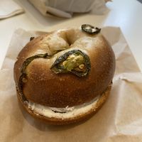 Jalapeño bagel with bacon scallion smear  at Ben & Esther's Vegan Jewish Deli in Seattle