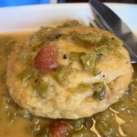 Vegan Breakfast Bunzy! It is stuffed with potatoes, tofu scramble, & vegan sausage. I had it smothered in green chili. They also have VioLife cheese available!   at Bunzy's & Booze in Colorado Springs