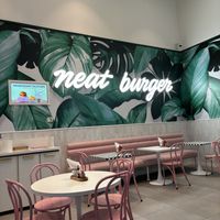 Clean, bright & adorable pink tables  at Neat Burger - Dubai Mall in Dubai