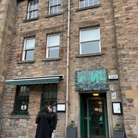 Street view of exterior with a couple waiting to see if they can get a table as a walk in OR waiting due to being early... at Soul Vegan in Edinburgh