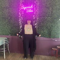 Taking a picture by their cute wall   at Veganish Vibes in Baton Rouge