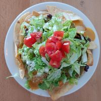 Nachos supreme, piled so high! at Itality Plant Based Foods in Albuquerque