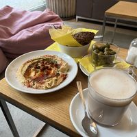 Hummus, marinated olives and (oat milk) chai latte  at Nude Zurich in Zurich