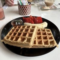 Vegan waffle with strawberry, banana, and maple syrup. Strawberry juice on the side.  at Bowl Acai Bar in Puerto Ayora