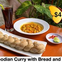 Delicious Cambodian Curry with wholegrain bread roll and juice of choice. at Butterfly Paradise  in Siem Reap
