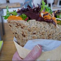 The technique for eating it is written on the wall! You really need to squash it as flat as you can. at Mano Wraps in Busselton