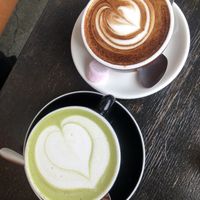 Matcha latte and mochaccino (I don’t think the little sweet is vegan)  at Hustl. cafe in Queenstown