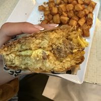 Not a great pic, but I was so excited to eat I forgot to take a nice one before. Chive biscuit with vegan egg, cheddar, and sausage. 🤌🏽  at Square Cafe in Pittsburgh