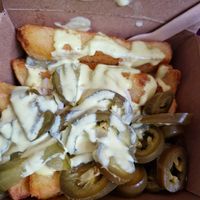 Cheesy pickle topped chunky chips. at Falafia in Beverley