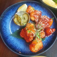 KOREAN FRIED CAULIFLOWER: Crispy cauliflower tossed in gochujang with sesame, coriander & pickled cucumber at Bill's in Manchester