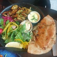 VEGAN SHAWARMA: Marinated in Bill's blend of herbs & spices. Served with garlic flatbread, chopped salad, house pickles, chillies, mint yoghurt & Hummus at Bill's in Manchester