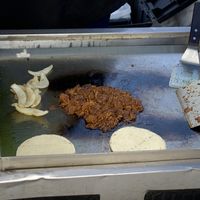 Jackfruit tacos and grilled onions being prepared   at hippiestacos in Long Beach
