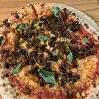 Pizza with vegan cheese, olives and roasted aubergine. SO good.  at Solo Grano in Nottingham