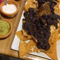 Nachos with vegan cheese, vegan sour cream and black beans at Mamalupe Arcos in Arcos De La Frontera