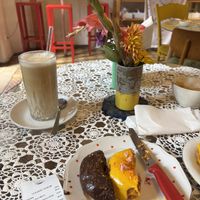 Shared half the mango passionfruit and half chocolate nut donuts, also iced coffee. So good!  at Donuterie in Prague