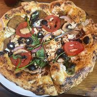 Can’t remember the name but I added pepperoni, onions, and tomatoes.  Had a little spice to it  at Pizzeria Distrito Vegano in Merida
