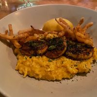 Sweet potato grits topped with blackened king oyster mushrooms, crispy onion, and savory pan sauce. at La Setima Club in Tampa