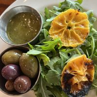 Salad course served with oily olives and dressing on the sidee  at Main Deck in Penn Yan