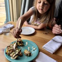 Roasted potatoes with nacho cheese and chives at Cafe Gratitude in Kansas City