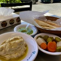Mesbaha hummus, pickled vegetables, lemon chili sauce and breadd  at Modern Abu Jbara - Jabal Amman in Amman