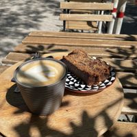 Oatmilk cappuccino and delicious vegan bananabread  at Hana Corner Cafe in Tirana