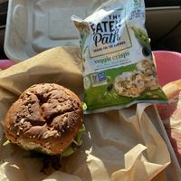 Pinto burger Togo with chips and watermelon slice.   at Viridescence Bottles and Bites in Pilot Mountain