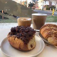 Cinnamon bun, almond croissant, hot choc and flat white  at To Live For in Vancouver