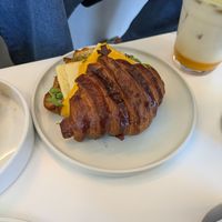 Breakfast croissant sandwich with sausage at To Live For in Vancouver