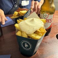 Curry sauce (red, it’s sweet and savoury) and truffle sauce (white in front)  at Potato Project in Lisbon