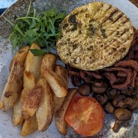 Vegan celeriac steak plus sides including tobacco onions at The Snooty Tavern in St Neots