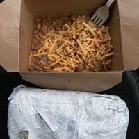 Burrito and side of rice and beans with vegan cheese on top  at Left Coast Siesta in Manzanita