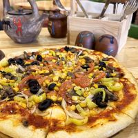 Hearty veganized Vegetarian pizza, we asked to make without cheese. Fresh tomato sauce made from grated tomatoes. Pizza dough is originally vegan. at Carahunge in Stepanavan