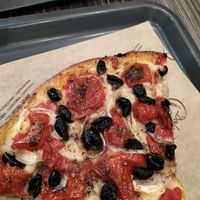 Focaccia with onions tomatoes and olives at Panificio Dolce & Pane in Bari
