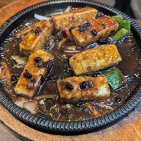 Sizzling fried tofu in black bean sauce at Tofu Vegan - Spitalfields in East London