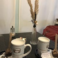 Hot chocolate stirrers and a mug of hot oat milk  at Café Allerlei in Trier