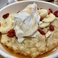 Porridge w/goji berries, bananas, and coconut yogurt   at The White Hart Hotel Restaurant in Kingston Upon Thames