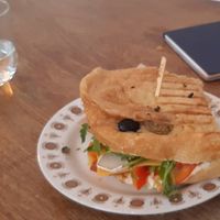 Crispy focaccia sandwich with seitan chorizo and cashew camembert at KŸNO in Brno