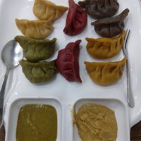 Momo set. Great leaf momo, beetroot momo, pumpkin momo and mushroom and vegetable filling. The sauces were amazing as well. at Sat Saheb in Kathmandu