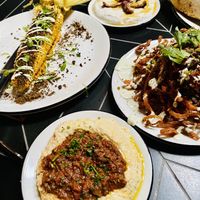 Lots of food ordered - Elote, hummus with Ragu, yogurt with dates, onion strings, pita  at Sin Muerte in Phoenix