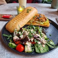 Pumpkin Spice Ciabatta with planted meat and salad on the side at greenhouse Café & PopUp in Esslingen