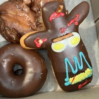 Ridiculous!!!! Apple fritter, voodoo doll, & chocolate raised! Exceptional!!!!!!!!  at DEN - Voodoo Doughnut - Concourse B in Denver